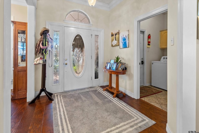 foyer entrance featuring ornamental molding, washer / clothes dryer, and dark hardwood / wood-style floors