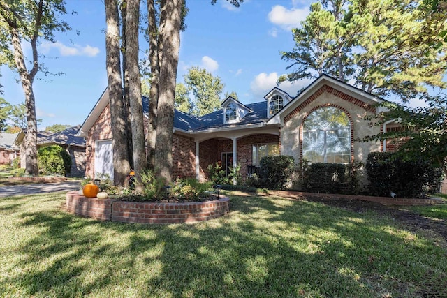 view of front of property featuring a garage and a front yard