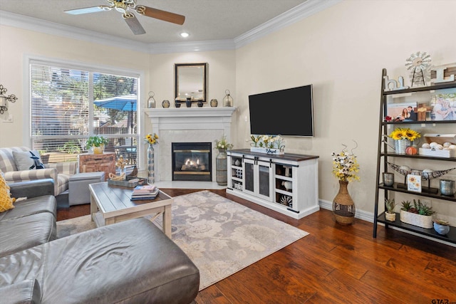 living room featuring a textured ceiling, dark hardwood / wood-style floors, crown molding, and ceiling fan