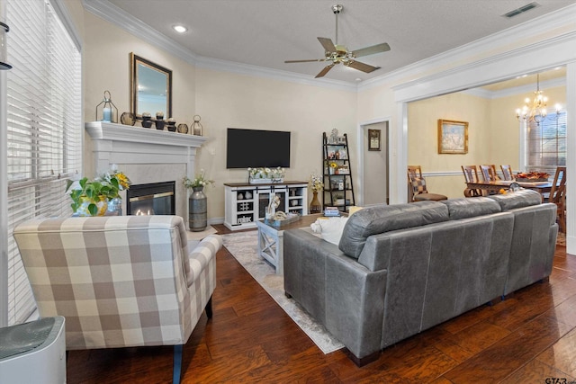 living room featuring dark hardwood / wood-style flooring, crown molding, and plenty of natural light