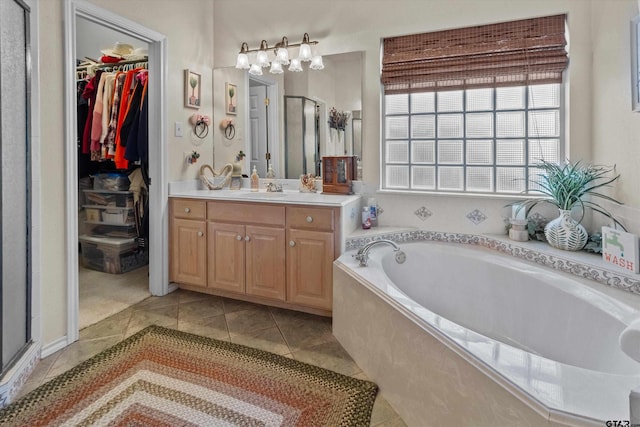 bathroom featuring tile patterned flooring, vanity, and independent shower and bath