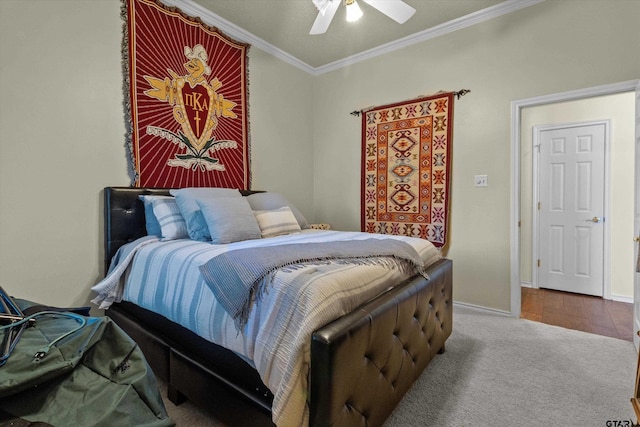 bedroom featuring hardwood / wood-style floors, ceiling fan, and crown molding