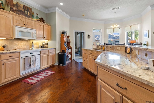 kitchen featuring dark hardwood / wood-style floors, light brown cabinetry, pendant lighting, an inviting chandelier, and white appliances