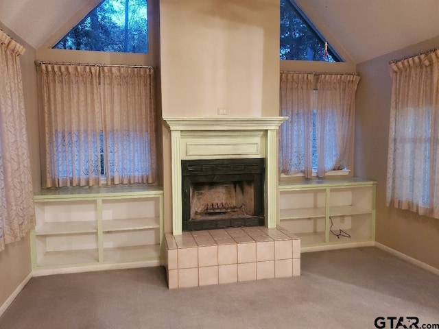 unfurnished living room featuring carpet flooring, a fireplace, and lofted ceiling