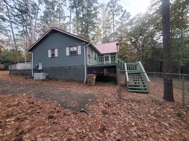 view of side of property with a wooden deck