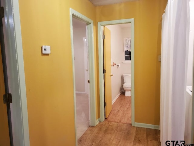 corridor with light wood-type flooring