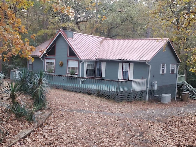 view of front facade with cooling unit and a deck