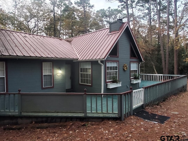 rear view of property featuring a deck