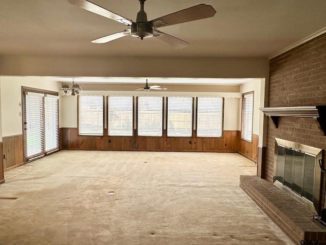 unfurnished living room featuring brick wall, light colored carpet, and wood walls