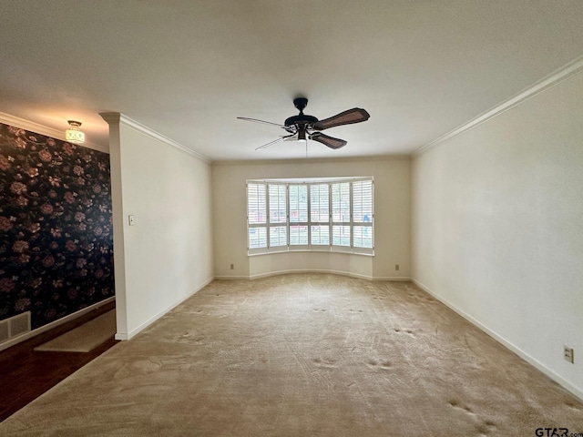 carpeted spare room with ceiling fan, a textured ceiling, and ornamental molding