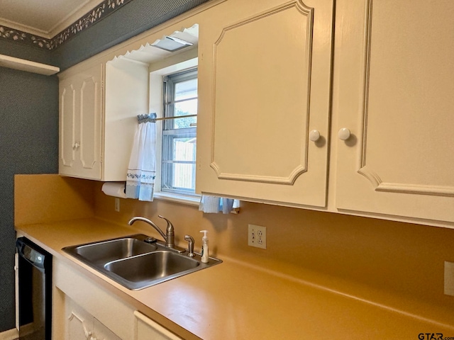 kitchen featuring dishwasher, white cabinets, and sink