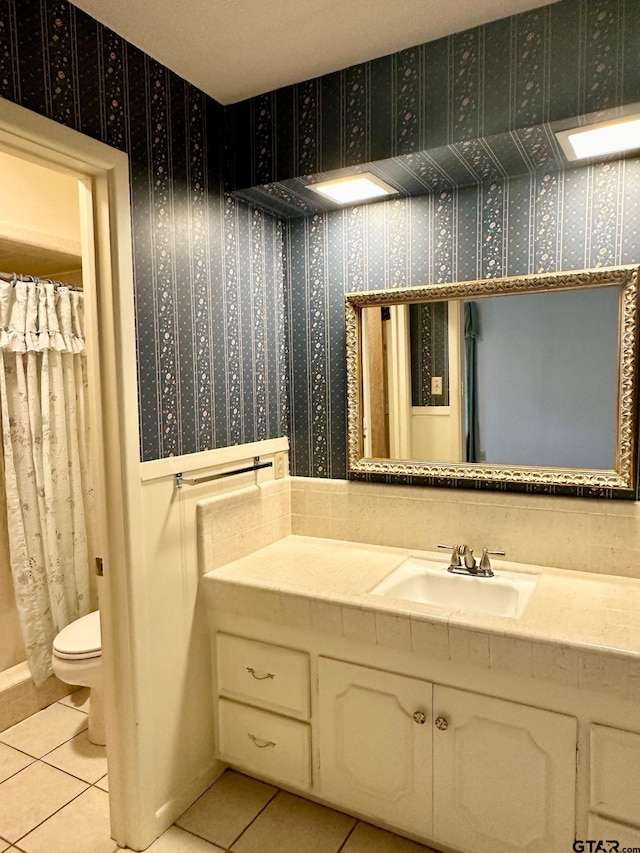 bathroom with tile patterned floors, vanity, and toilet