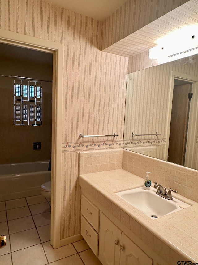 bathroom featuring tile patterned flooring, vanity, and toilet