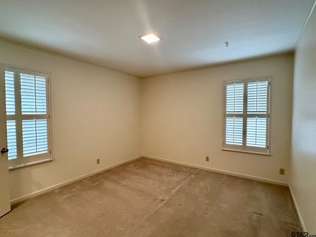 carpeted spare room with a healthy amount of sunlight