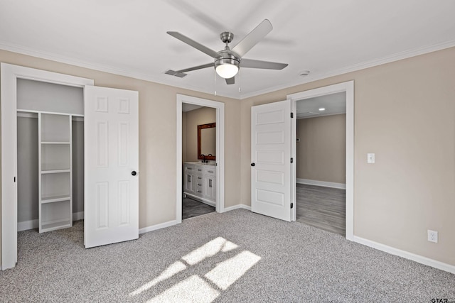 unfurnished bedroom featuring connected bathroom, crown molding, ceiling fan, and carpet flooring