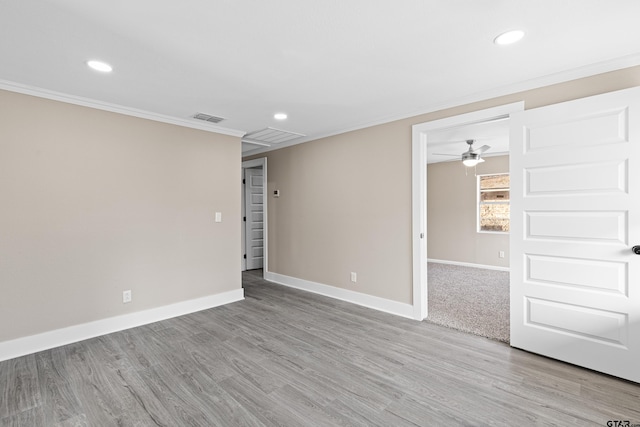 spare room featuring ceiling fan, ornamental molding, and light hardwood / wood-style flooring