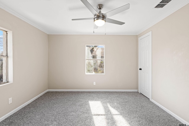 spare room with ornamental molding, carpet, a healthy amount of sunlight, and ceiling fan