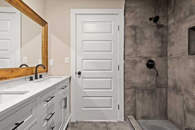 bathroom with vanity and tiled shower