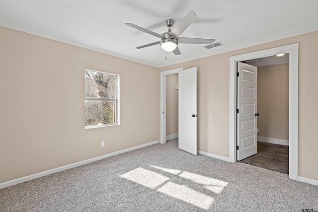 unfurnished bedroom featuring crown molding, ceiling fan, and carpet flooring