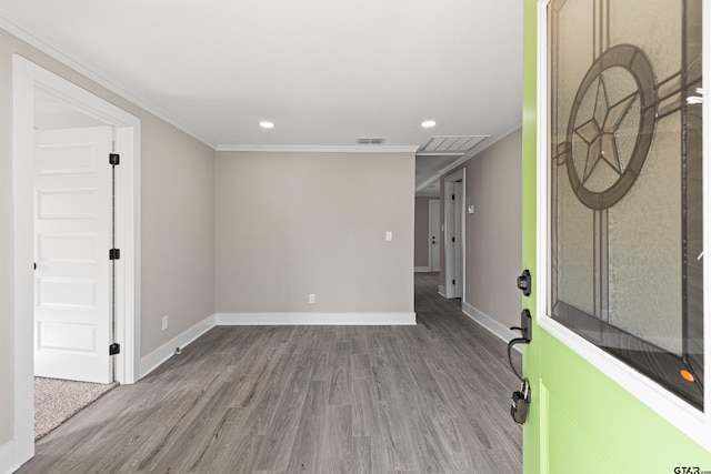 spare room with wood-type flooring and crown molding