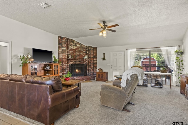 living room featuring lofted ceiling, a brick fireplace, a textured ceiling, and ceiling fan