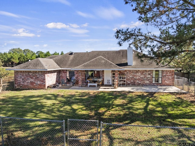 back of property with a yard and a patio area