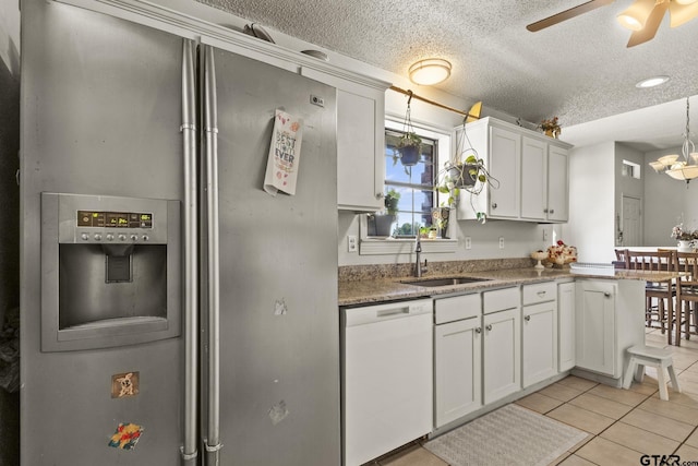 kitchen with white cabinetry, sink, light tile patterned floors, white dishwasher, and stainless steel fridge with ice dispenser