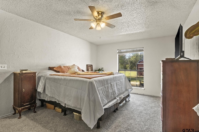 carpeted bedroom featuring ceiling fan and a textured ceiling