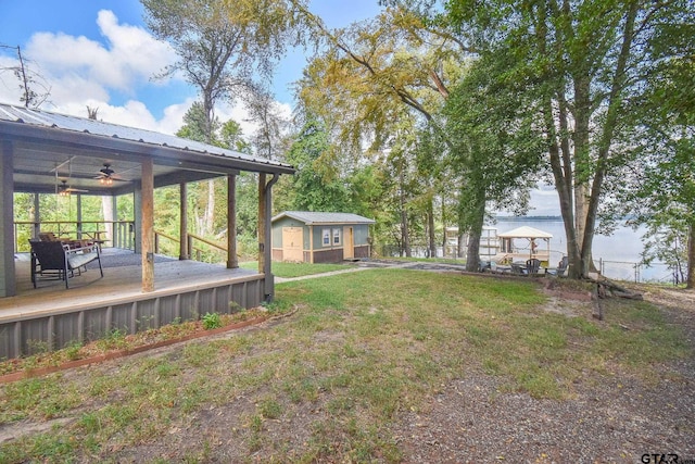 view of yard with ceiling fan and an outdoor structure