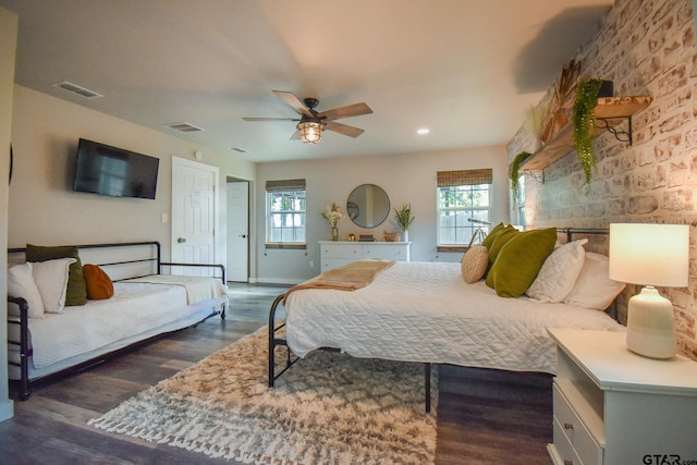 bedroom with multiple windows, dark wood-type flooring, and ceiling fan