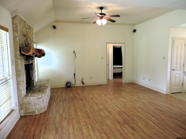 525 Peach Tree Rd, Gun Barrel City, TX 75156 - unfurnished living room featuring a ceiling fan, light wood finished floors, healthy amount of natural light, a stone fireplace, and lofted ceiling