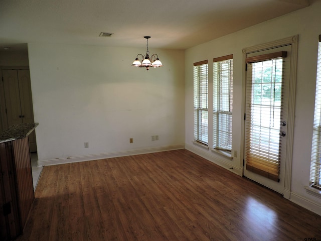 525 Peach Tree Rd, Gun Barrel City, TX 75156 - unfurnished dining area with wood finished floors, healthy amount of natural light, and a chandelier