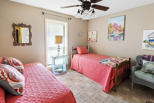 bedroom with a ceiling fan and light carpet