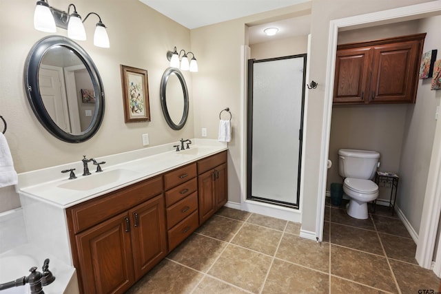 bathroom featuring a sink, toilet, a stall shower, and double vanity