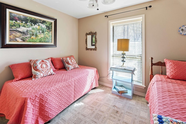 carpeted bedroom featuring baseboards