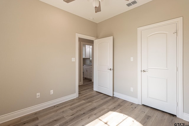 unfurnished bedroom with light hardwood / wood-style flooring and ceiling fan