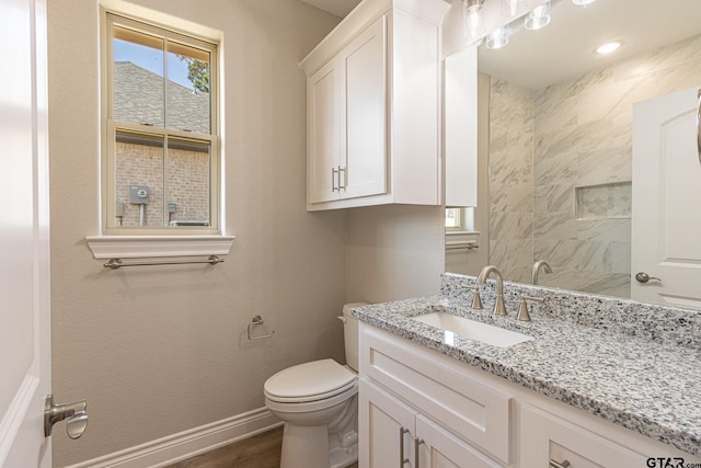 bathroom with vanity, wood-type flooring, and toilet