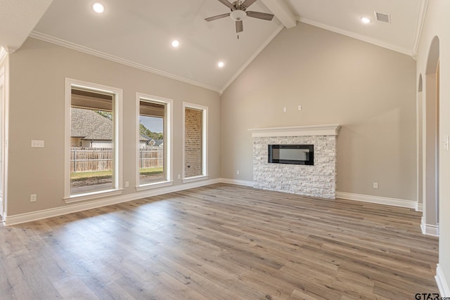 unfurnished living room with high vaulted ceiling, light wood-type flooring, beamed ceiling, ceiling fan, and a fireplace