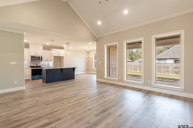 unfurnished living room with ornamental molding, sink, high vaulted ceiling, and light hardwood / wood-style flooring