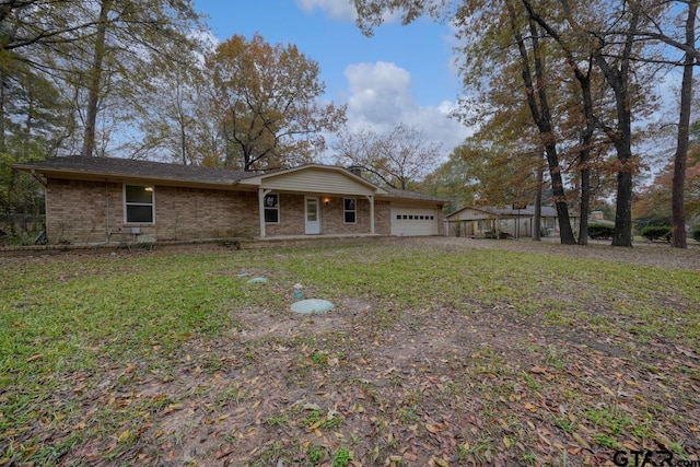 back of property with a yard and a garage