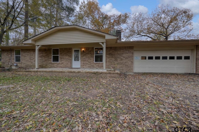 single story home with a porch and a garage