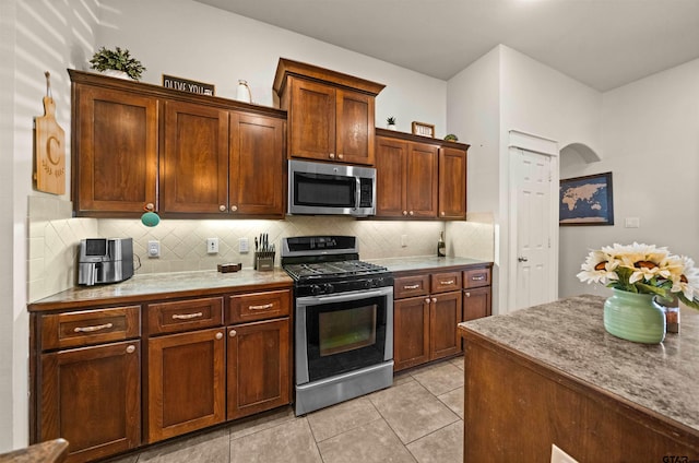 10926 Westhaven Cir, Flint, TX 75762 - kitchen featuring appliances with stainless steel finishes, tasteful backsplash, and light tile patterned flooring