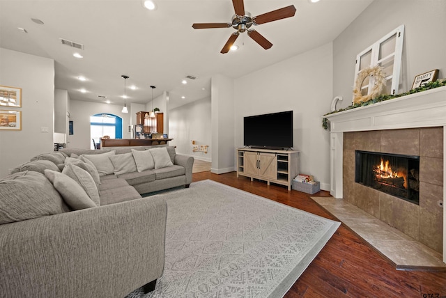 10926 Westhaven Cir, Flint, TX 75762 - living room with wood finished floors, a tiled fireplace, a ceiling fan, and recessed lighting