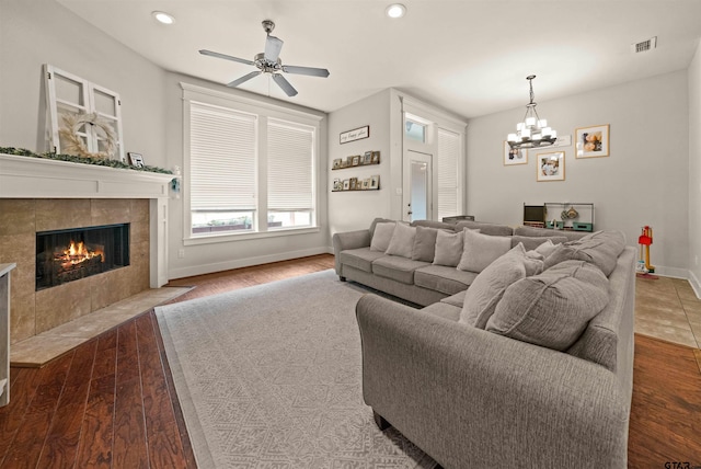 10926 Westhaven Cir, Flint, TX 75762 - living room featuring a fireplace, recessed lighting, wood finished floors, a chandelier, and a ceiling fan