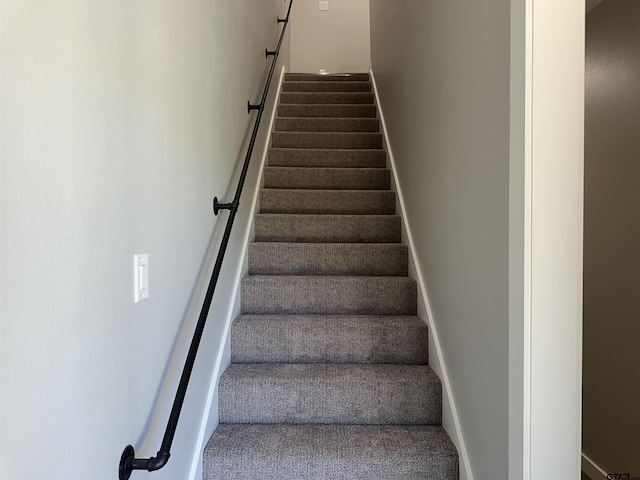 stairs featuring carpet flooring