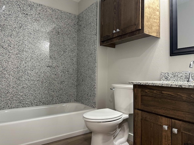 bathroom with toilet, wood finished floors, and vanity