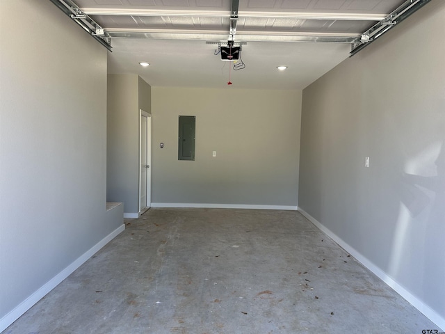 garage featuring baseboards, a garage door opener, and electric panel