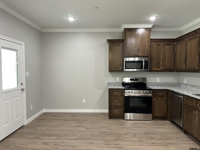 kitchen featuring dark brown cabinets, light wood-style floors, appliances with stainless steel finishes, and crown molding