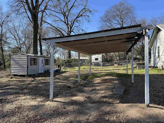 view of yard featuring a carport and a shed