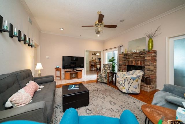 living room with a brick fireplace, parquet floors, crown molding, and ceiling fan